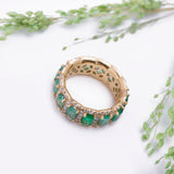 Halo Green Emerald and Diamond Eternity Band Ring in 18k Yellow Gold.